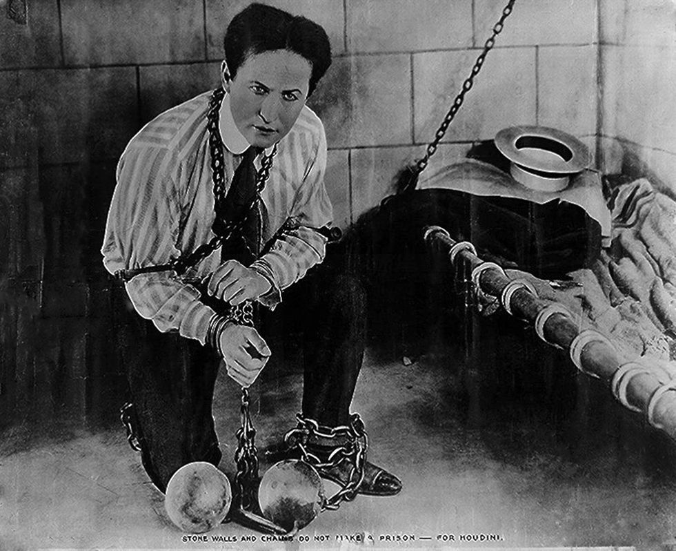 houdini wrapped in chains in prison cell