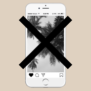 an iphone displaying instagram and a beach photo with an x through it
