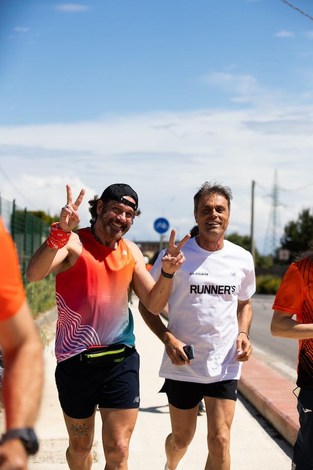 Two male runners celebrating during a marathon