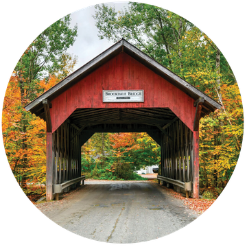 a red covered bridge in stowe, vermont