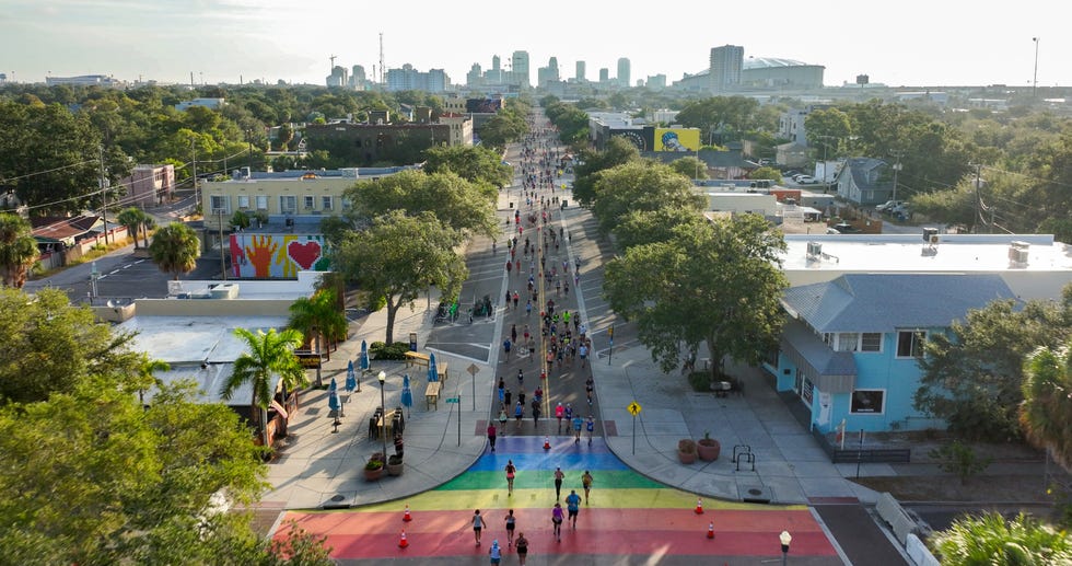 an aerial view of a crowd of runners in a race in a city setting