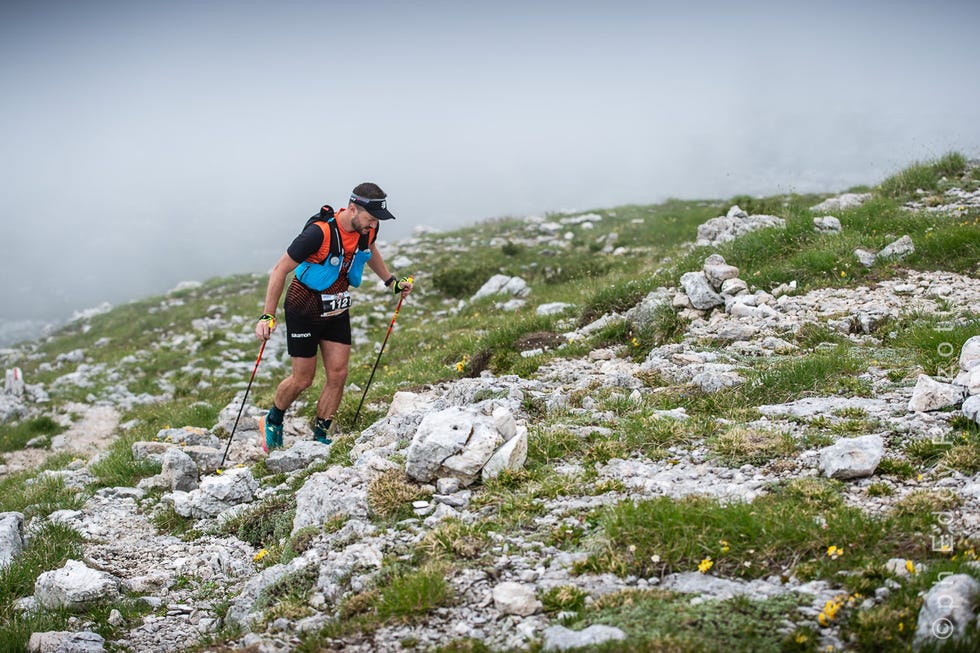 person trekking on a rocky mountain path