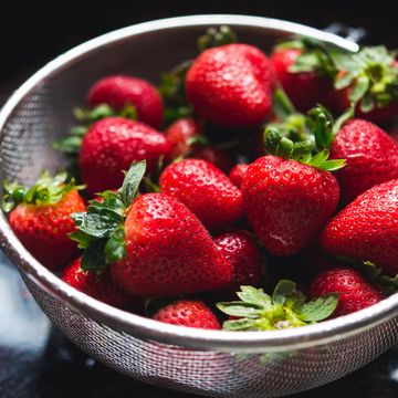 strainer filled with strawberries
