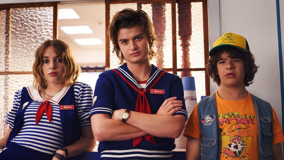 steve and robin wear scoops ahoy uniforms in a scene from stranger things' third season