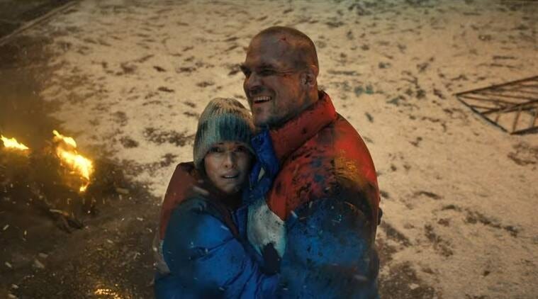 joyce and hopper embrace in a scene from stranger things 4