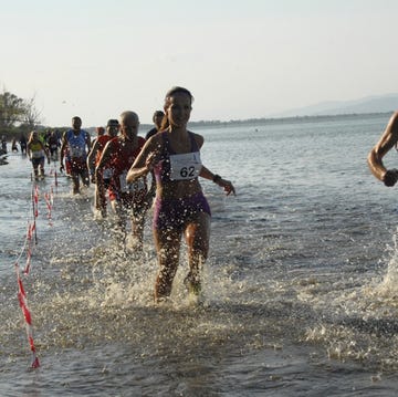 participants competing in a water race along a shoreline participants competing in a water race along a shoreline