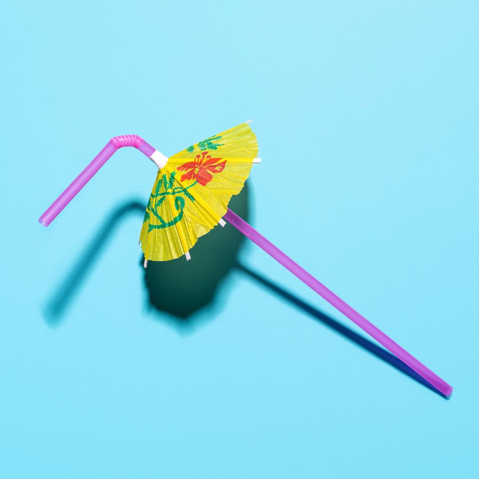 umbrella parasol drinking straw on blue background