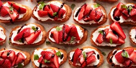 sliced strawberries on top of ricotta spread on crostini drizzled with balsamic