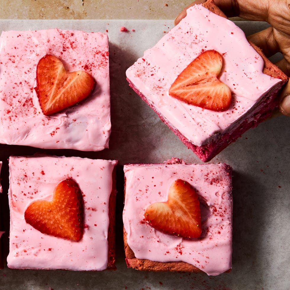 pink brownies topped with pink icing and strawberry hearts