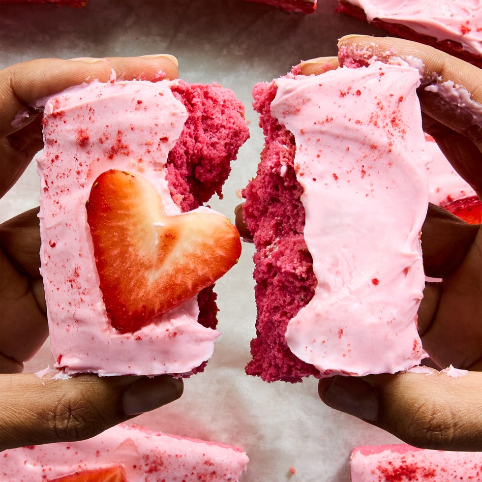 pink brownies topped with pink icing and strawberry hearts