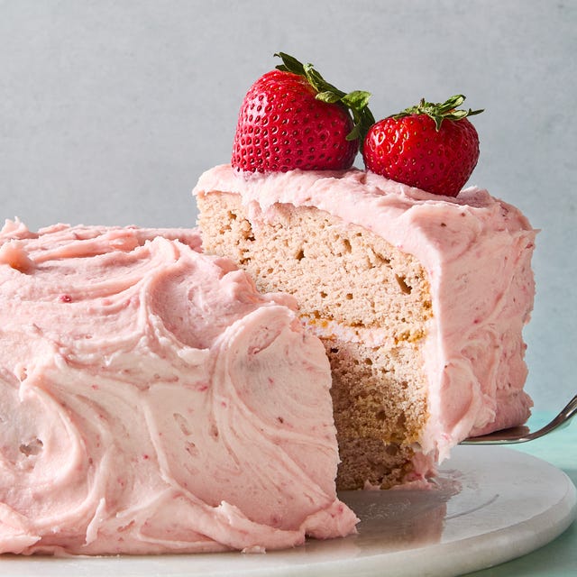 Strawberry Cake layered strawberry cake with pink icing and a strawberry on top