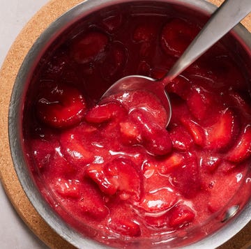 jammy strawberry compote in a pot with strawberries