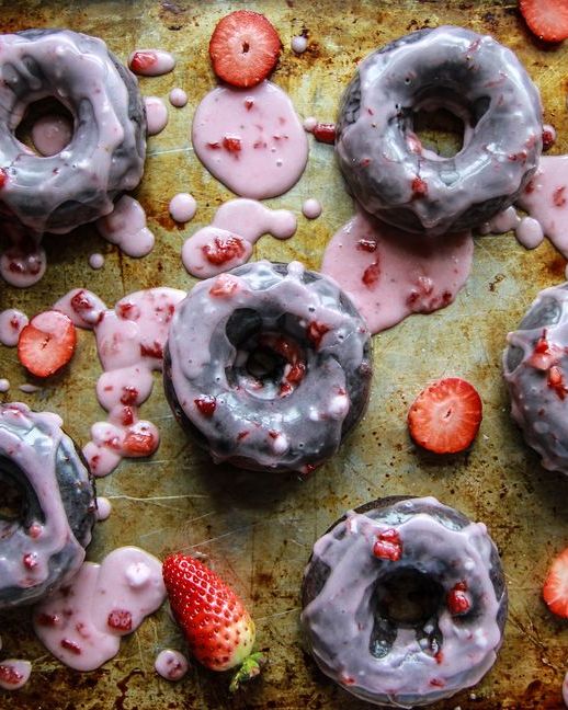 chocolate donuts with strawberry glaze on sheet pan