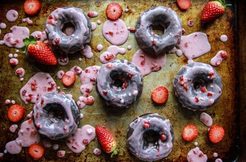 chocolate donuts with strawberry glaze on sheet pan