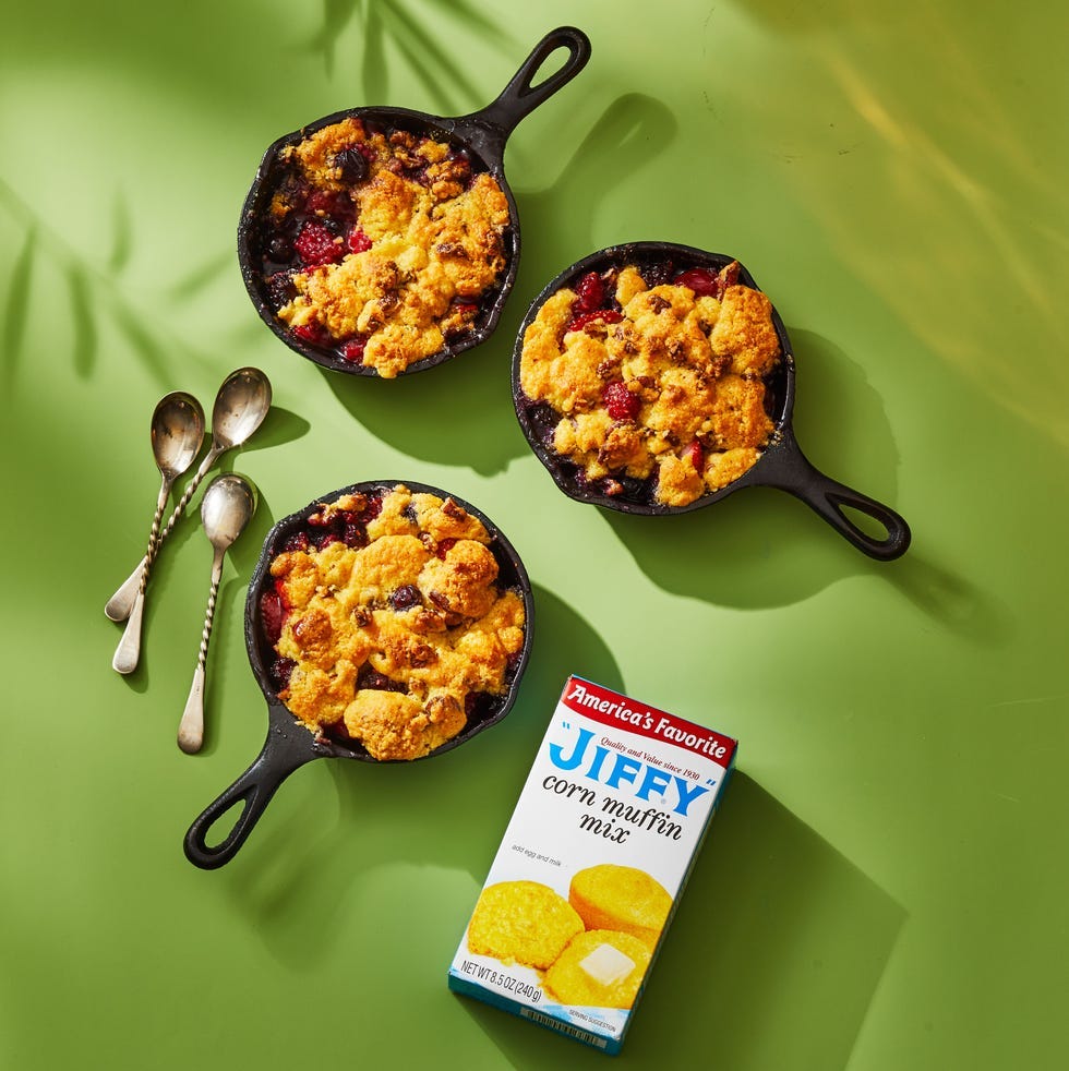 mixed berry cornmeal cobbler in a cast iron pans
