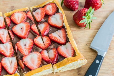strawberry nutella puff pastry on wood surface with knife