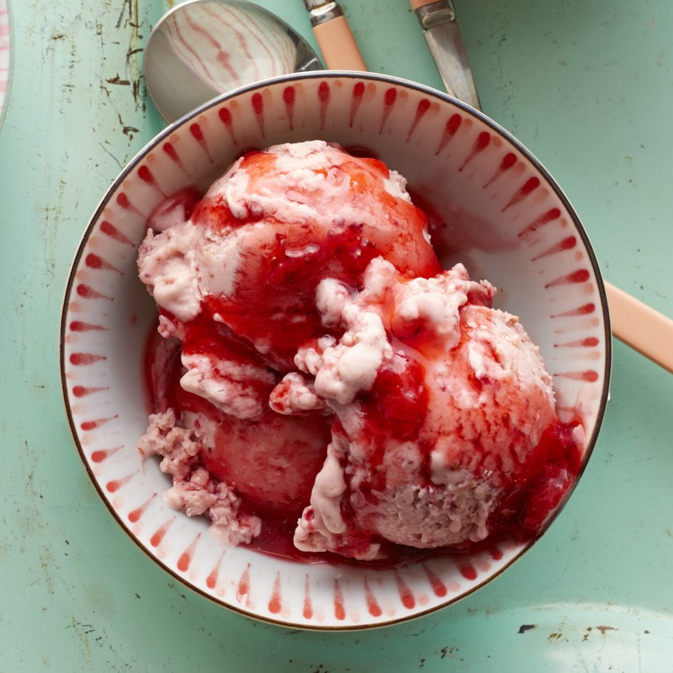 strawberry sauce over ice cream in pink bowl