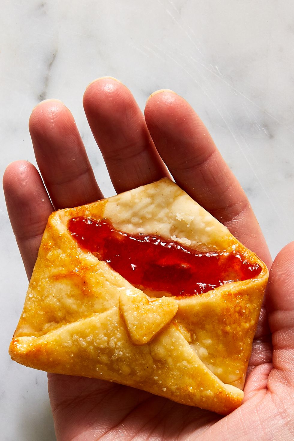 strawberry jam filled cookies that are folded and baked to look like love notes