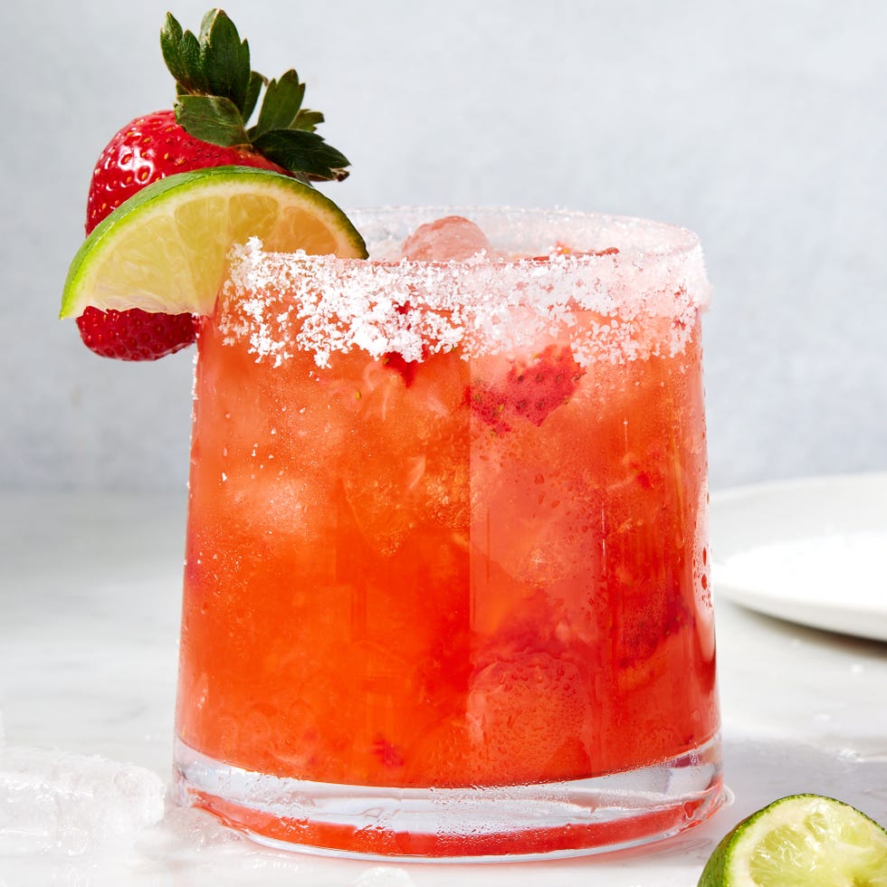 strawberry mezcal margarita with lime and strawberries