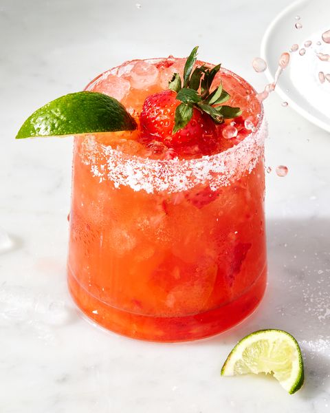 strawberry mezcal margarita with lime and strawberries