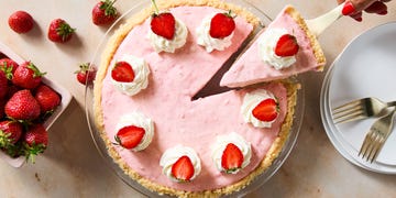 creamy strawberry pie topped with whipped cream and strawberries
