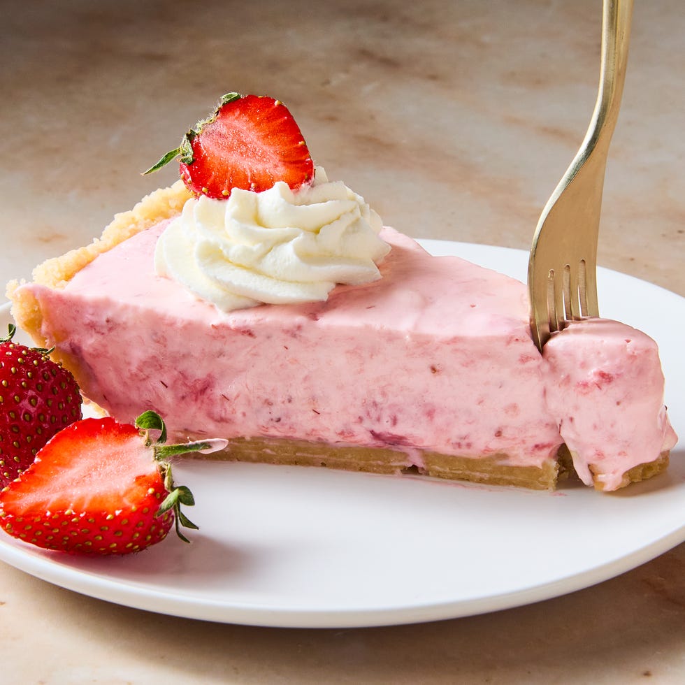 creamy strawberry pie topped with whipped cream and strawberries