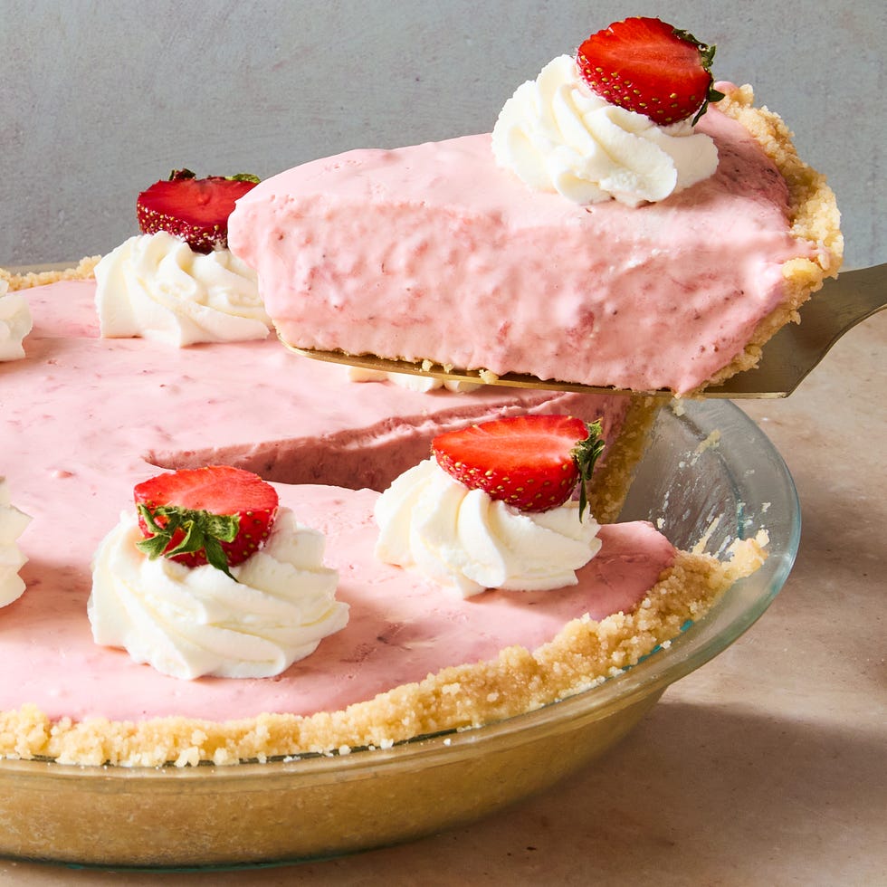 creamy strawberry pie topped with whipped cream and strawberries