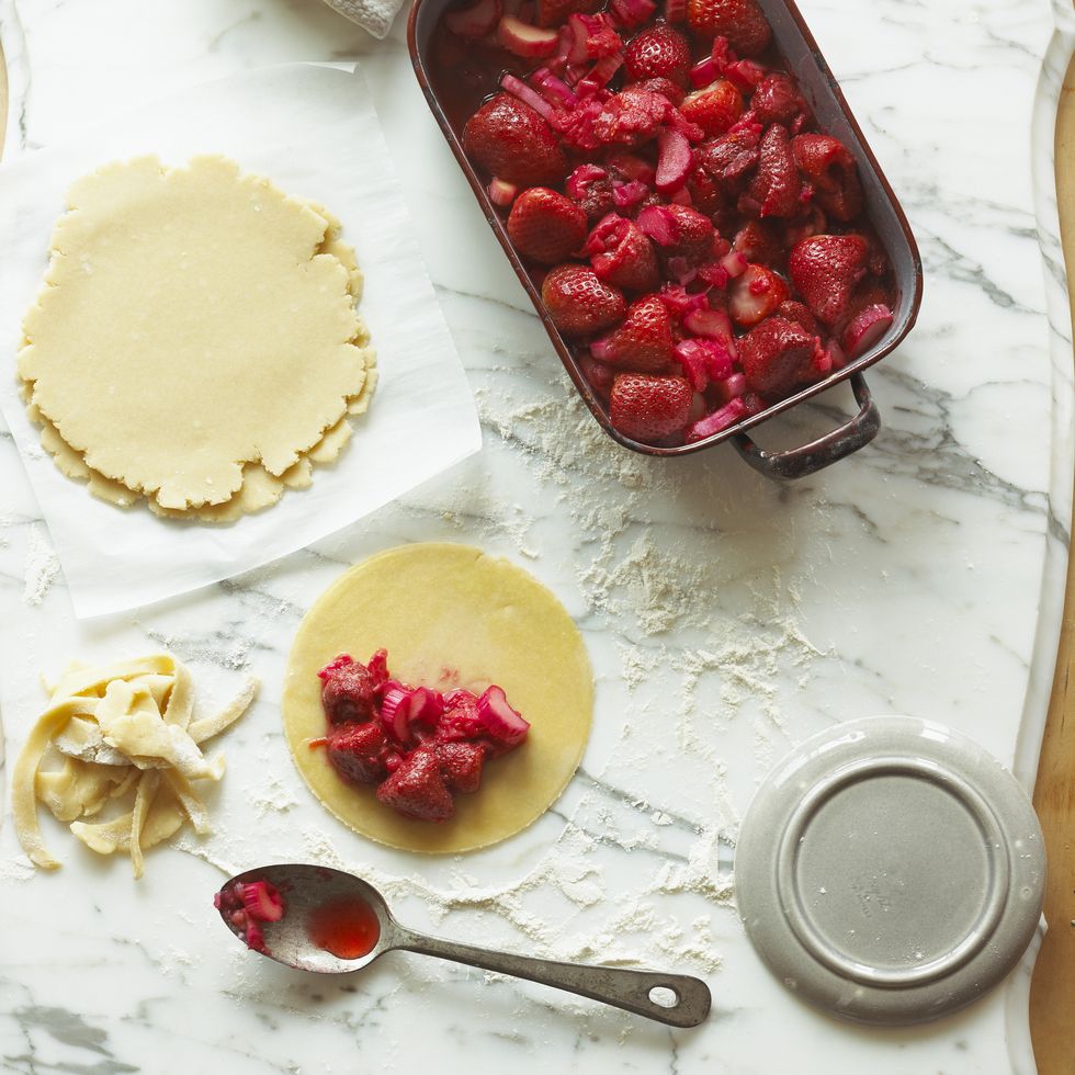 strawberry pie being prepared on marble