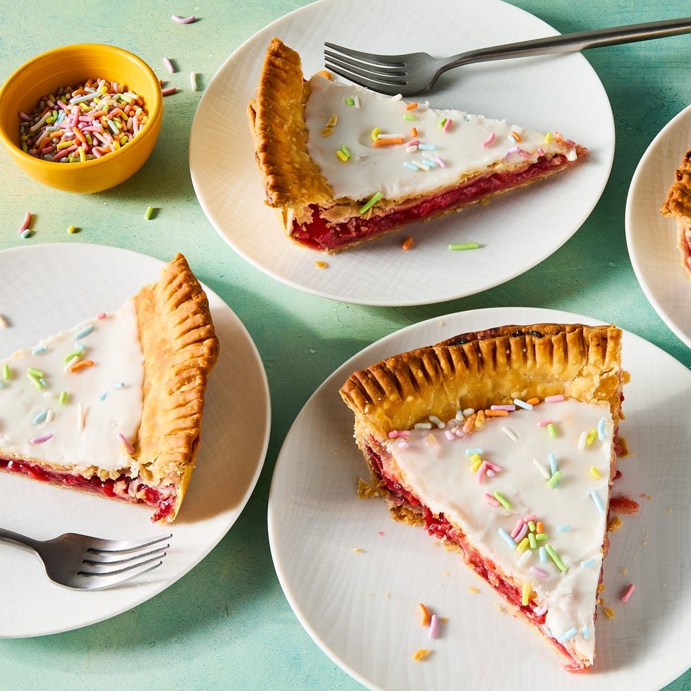 flaky pastry in a pie dish filled with strawberry filling and topped with icing and sprinkles