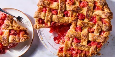 strawberry rhubarb filling in a pie with a lattice crust