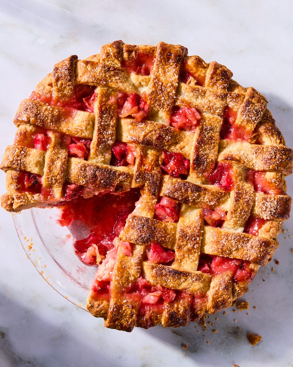 strawberry rhubarb filling in a pie with a lattice crust