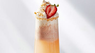 mimosa topped with strawberry ice cream, whipped cream, a strawberry slice and crushed graham crackers