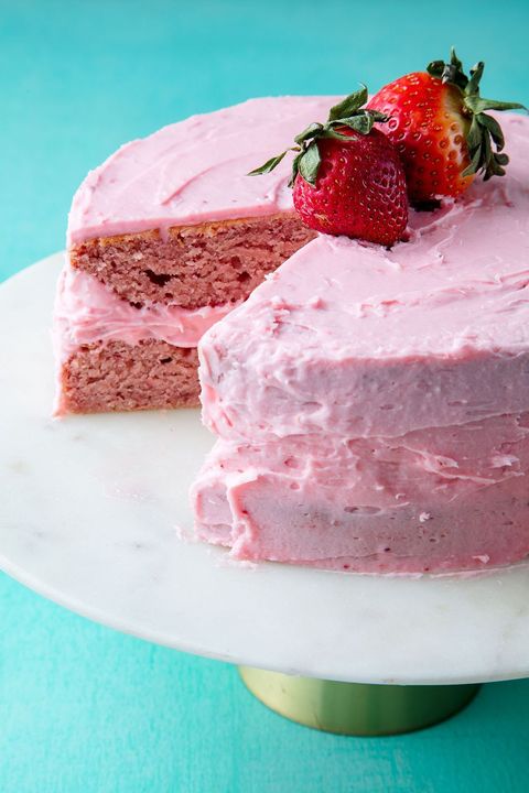 strawberry layer cake on a marble cake stand