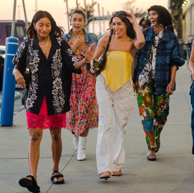 a group of women walks to a fashion week show wearing summer outfits to illustrate the best memorial day clothing sales 2022