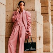a woman wears a pink suit to paris fashion week in a roundup of the best work clothes stores 2023