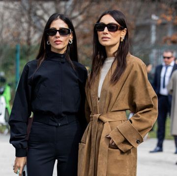 milan, italy february 24 gilda ambrosio wears black cropped pants, jacket, heels  giorgia tordini wears brown wild leather coat, boots outside ferragamo during the milan fashion week womenswear fallwinter 2024 2025 on february 24, 2024 in milan, italy photo by christian vieriggetty images