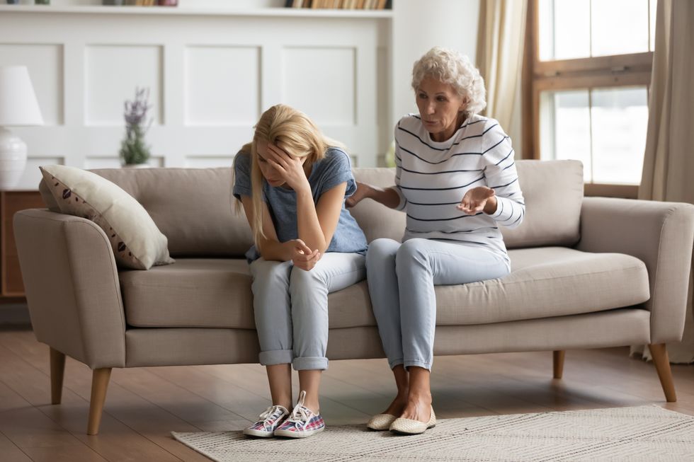 stressed millennial blonde woman ignoring angry senior old mother