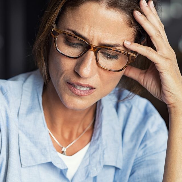 Stressed woman wearing eyeglasses