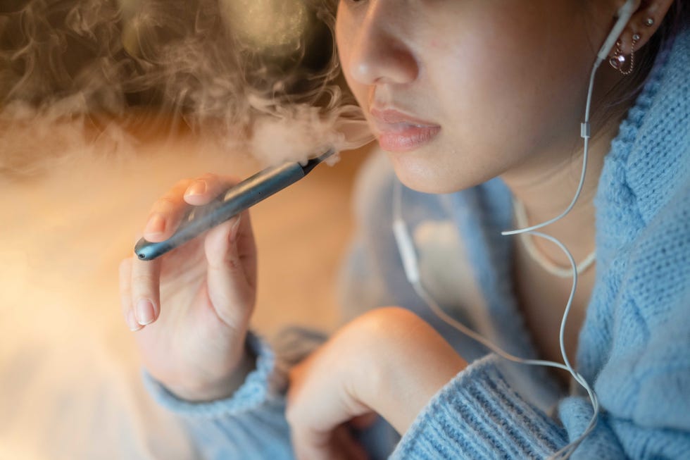 stressful woman smoking electronic cigarette for relax