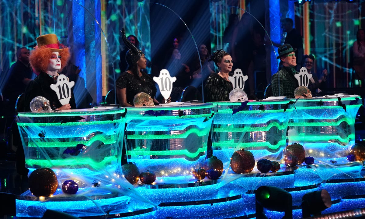 strictly come dancing judges craig revel horwood, motsi mabuse, shirley ballas and anton du beke hold up their ghost shaped 10 paddles on halloween week
