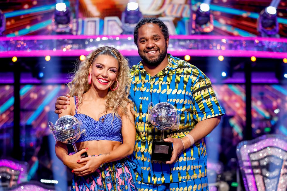 hamza and jowita hold glitterball trophies on strictly