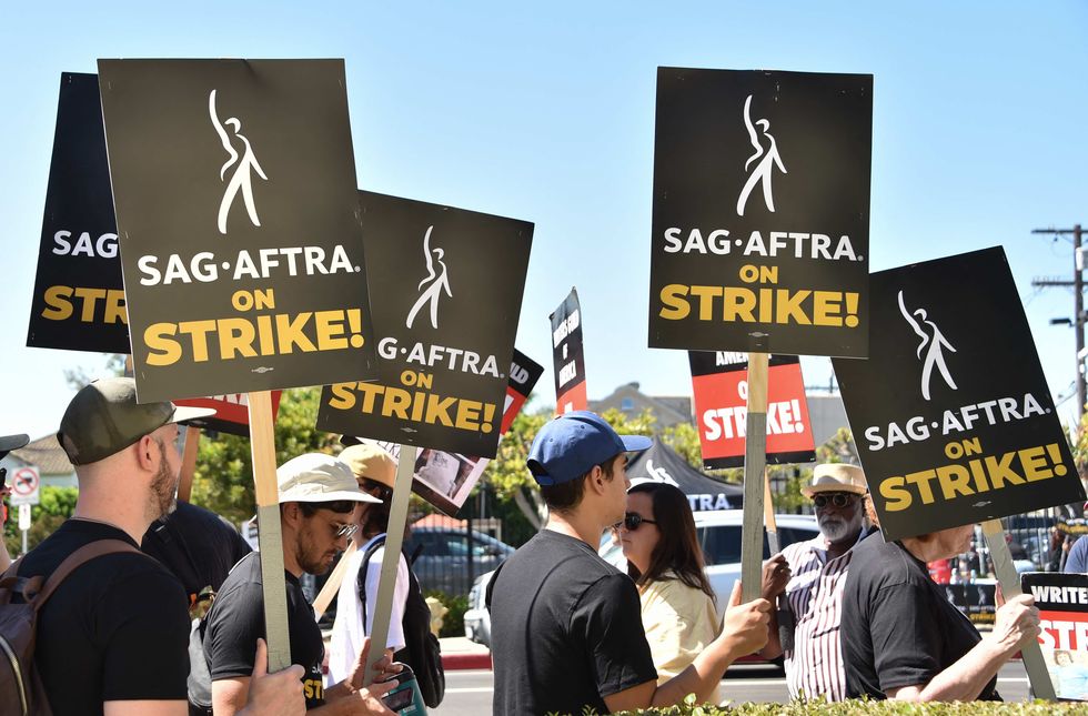 members of the writers guild of america and the screen actors guild walk a picket line outside paramount studios in los angeles, california, on july 14, 2023 tens of thousands of hollywood actors went on strike at midnight july 13, 2023, effectively bringing the giant movie and television business to a halt as they join writers in the first industry wide walkout for 63 years photo by chris delmas afp