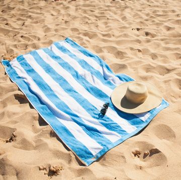 blue and white striped towel on beach