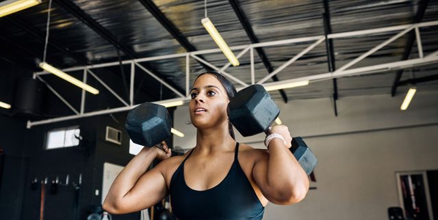 https://hips.hearstapps.com/hmg-prod/images/strong-female-athlete-performing-dumbbell-lunges-in-royalty-free-image-1740777779.pjpeg?crop=1.00xw:0.753xh;0,0.177xh&resize=640:*