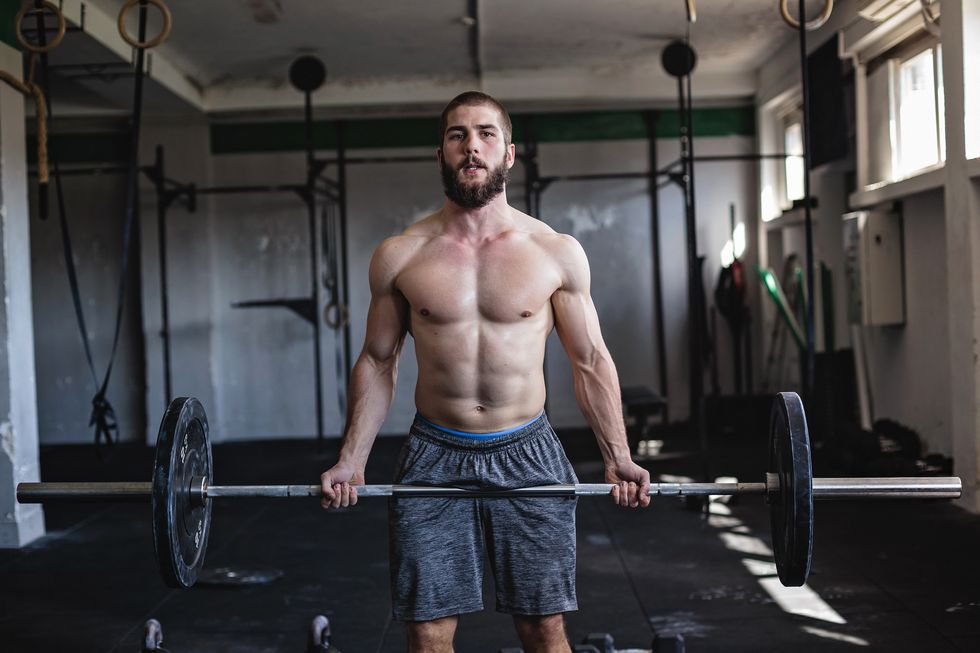 Strong man exercising with barbell
