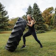 what is 75 hard challange strong woman pushing tire while exercising in backyard
