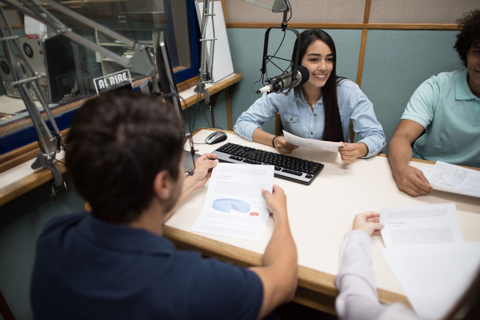students broadcasting from the university's radio station