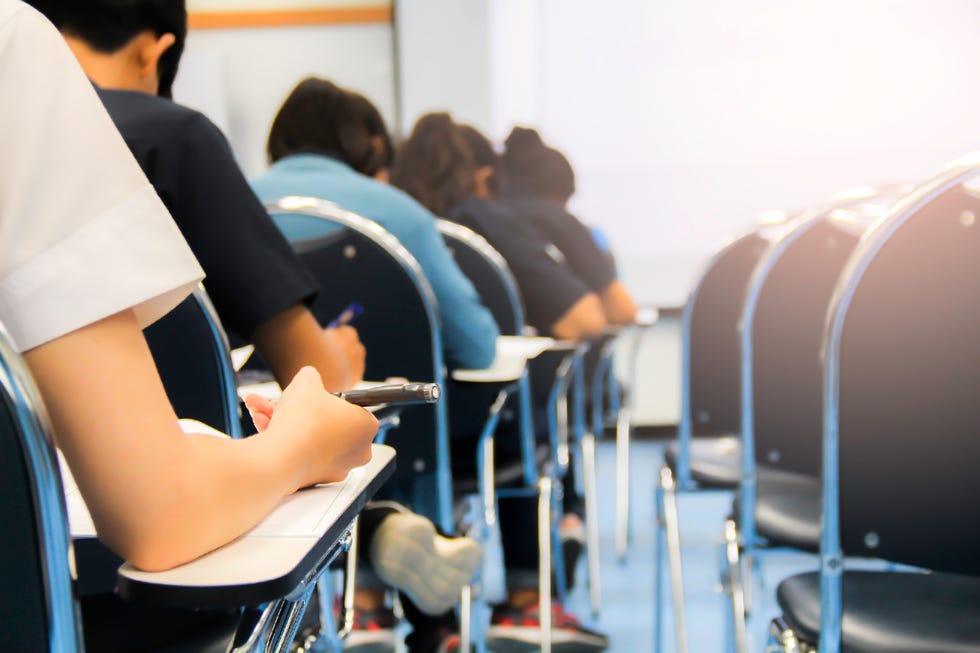 students giving exam test in university