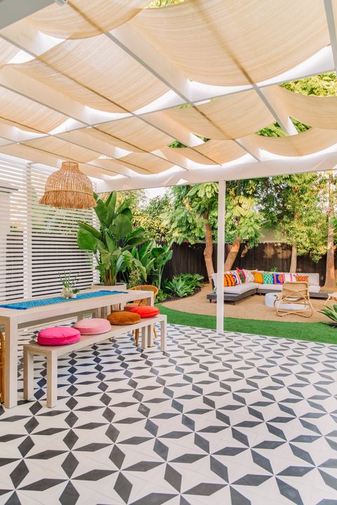 pergola with fabric shade over a tiled covered patio