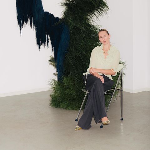 a person sitting in a chair with a peacock head